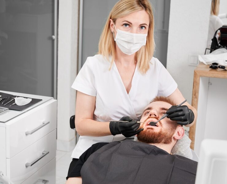 Woman stomatologist in medical mask looking at camera while examining male patient teeth with dental explorer and mirror. Concept of dentistry, stomatology and dental care. SSUCv3H4sIAAAAAAAACnRTy24dIQzdV+o/XLEOKvNm8gXdRO2+6sKAJ5eGO1wBkyqK8u8187ilVbJB+Ng+x8bm9fOn04kpiFaz+9Nrtsi2zi0xBUjWzwSLux0POBsMJfIcml6UABqbfLDgSlBB0ucZLkjgvDiX4bfVyWKCtESMWX2HNCR8JI4NvFFsJf7Y7NPhWJ2UQS72FcGls4aAXx6oDk1F3BVRcVE56pv6hTpFdng21Q8ov6O/OnyP5sFGjc7BjH4pyLbLz6NzeMRZv/ztI0MOLi9lJ4T9I9DovpcSFJ8GrXmrJ8Fl3yMfq4o8WAs1iZvgoZSJjVcYk9dP/7FXopfNexkmIFxisutgPqynognfkrfL2uY+roAOYZvgTsEGWY+VMA1vp3zopucwoOBg2rEbBUiCDwkGatCtrAUfaq14a8zEpWo7bugJEAcY5ShX/a1w9vQ7YbiUCwOLsb7YlWdPo88BTVHmNVht58cizafzusxHmvbLnEIeza1/5ry/gqINuD9NxIkHfoYYKdwceCGk6ev4S6Ez+7S+zs7KDO13Nqum7oaxbfpOjnXfNqLeA7Y/cbbEs5ZzEK2ztaZs3eYKGAyNaEaceNuPkg7ouNJDXhtd61q2ncGKnvDtDwAAAP//AwDFAvD27gMAAA==